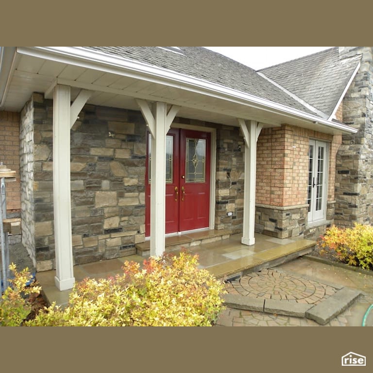 Stone sided entryway with red door with Stone Siding by Masonal Stone Inc