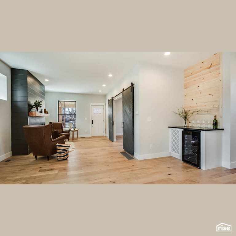 Entryway with gas fireplace and wine fridge with Integrated LED by Revolve Design Build