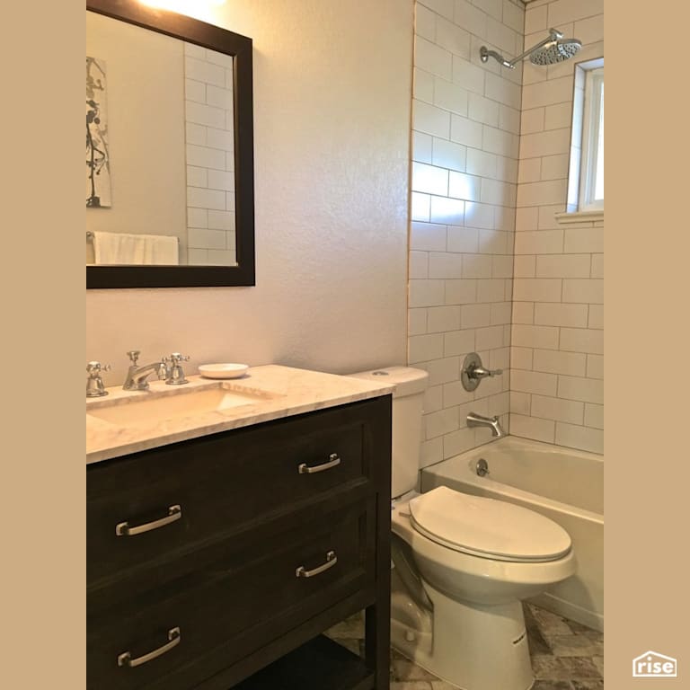 Dual flush toilet with low-flow showerhead with Dual Flush Toilet by Revolve Design Build