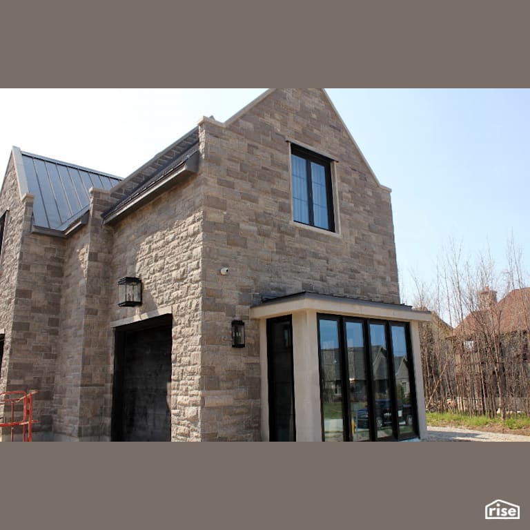 Exterior of House with Northern Grey Stone Siding with Accent Outdoor Lighting by Masonal Stone Inc