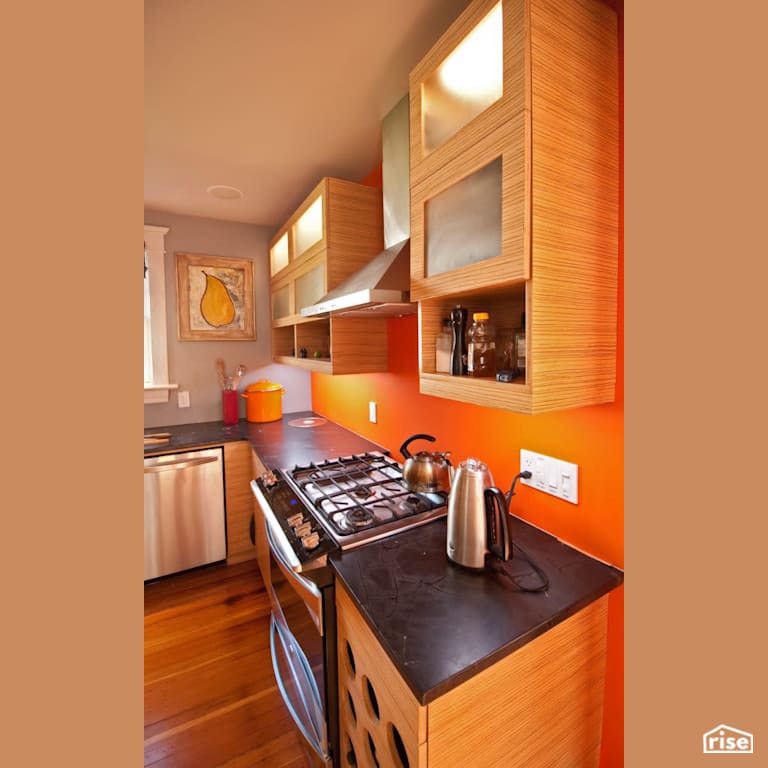 Orange Kitchen with Gas Range by RSI Projects