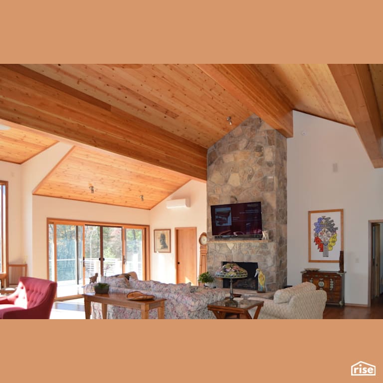 Large open living room with stone fireplace with Television by Alpen High Performance Products