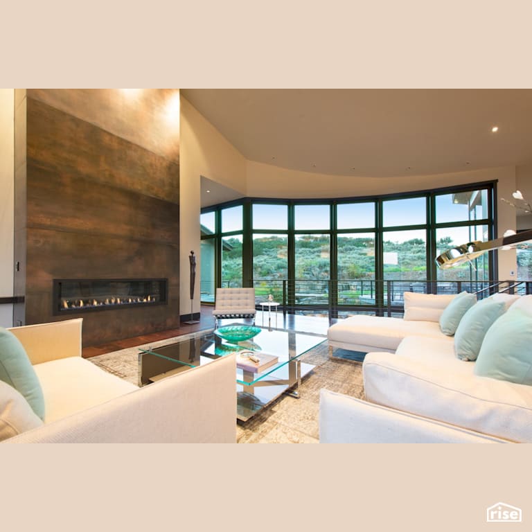 Living room with large windows and feature fireplace with Gas Fireplace by Alpen High Performance Products