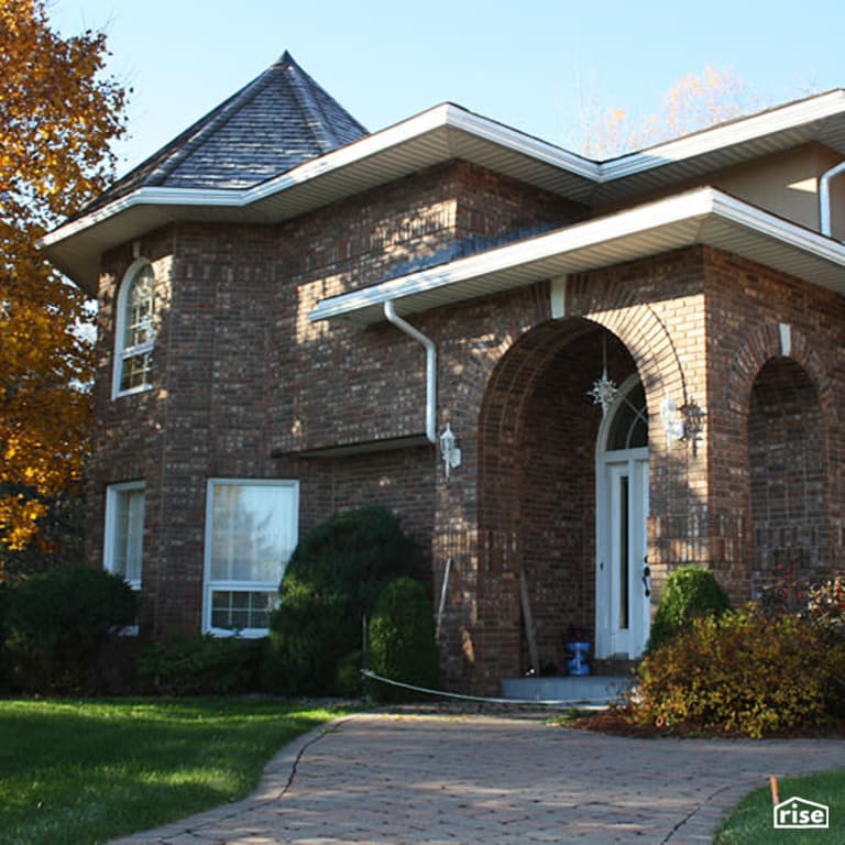 Exterior Stone Siding with Wall Mounted Outdoor Lighting by Jones Masonry