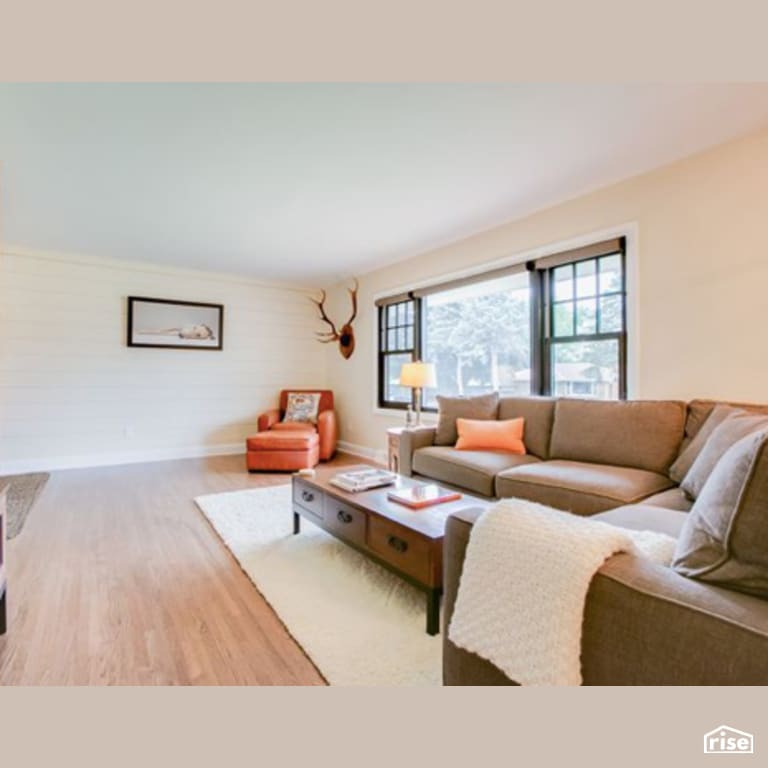 Living Room with Laminate Flooring by Constructive Builders