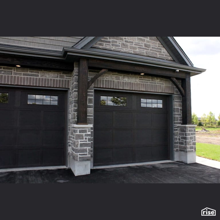 Garage door with stone siding and security camera with Stone Siding by Masonal Stone Inc