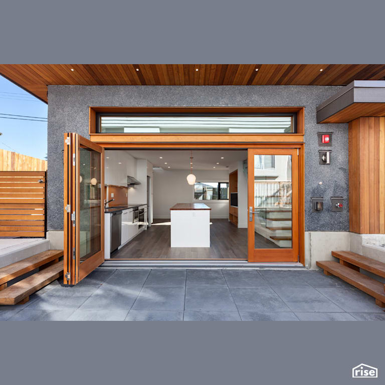 Newport House Backyard Patio Open Accordion Doors with Energy Star Exterior Door by Lanefab Design/Build
