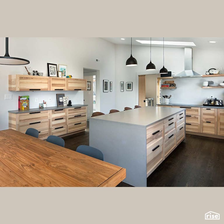 Open concept kitchen with wood cabinetry with Integrated LED by Deltec Homes