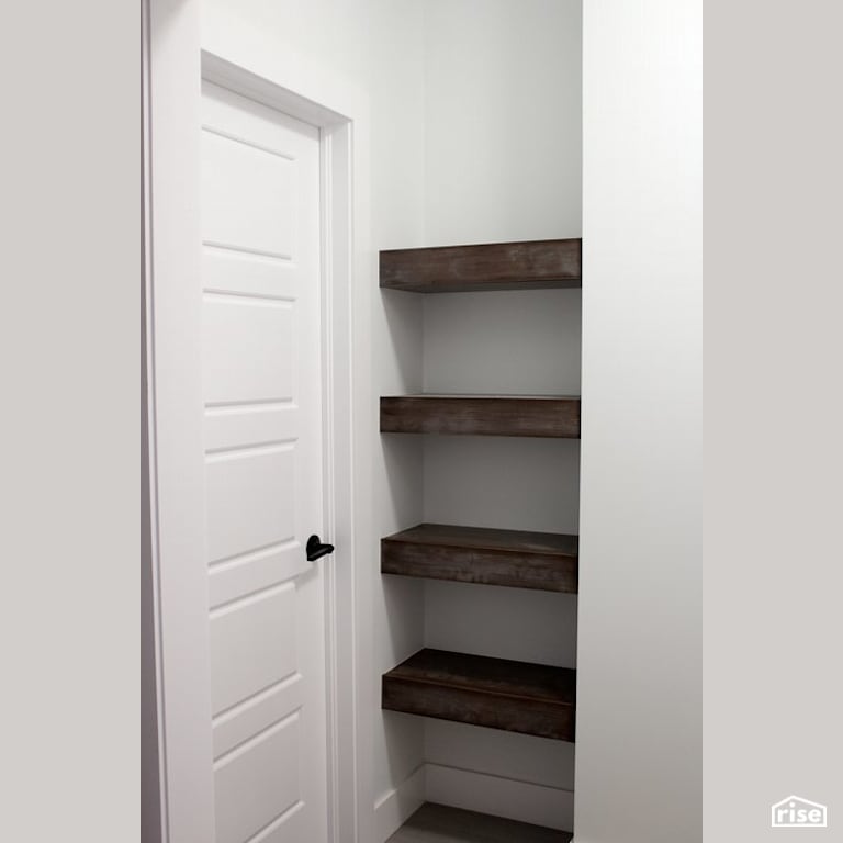 The Lauderdale - Closet with Reclaimed Hardwood by Justin Bowers Homes