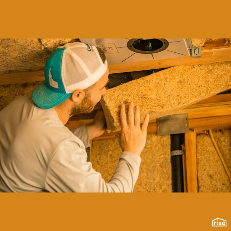 Pressing HempWool Batts Into Place with Hemp Batt Insulation by Hempitecture