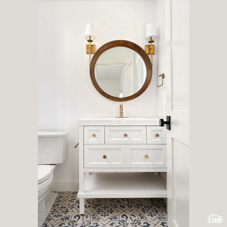 Single vanity with circular mirror with Low-Flow Bathroom Faucet by Revolve Design Build
