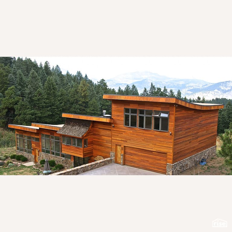 Beautiful hillside exterior with Solid Wood Door by Revolve Design Build
