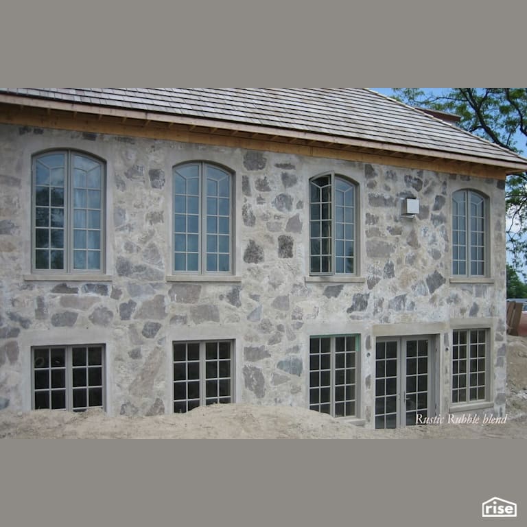 Rustic rubble siding with wood shingle roof with Stone Siding by Masonal Stone Inc