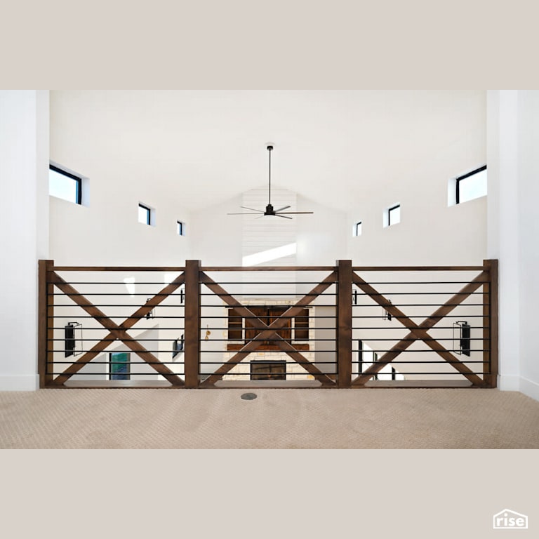 Second floor hallway looking to main floor with Fixed Window by Revolve Design Build
