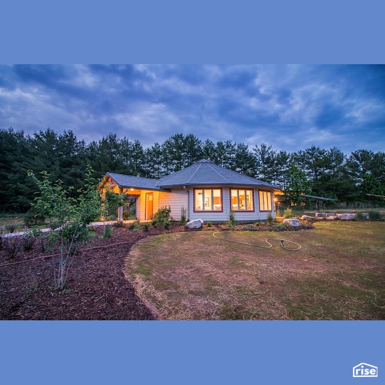 Landscaped roundhouse with solar panels with Energy Star Exterior Door by Deltec Homes