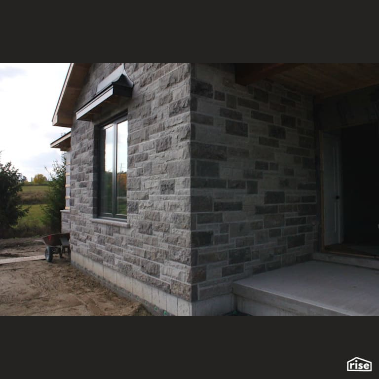 Stone sided house under construction with Stone Siding by Masonal Stone Inc