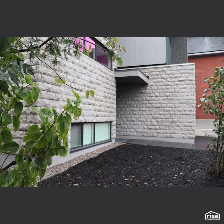 Mulched entryway with stone siding with Wood Mulch by Masonal Stone Inc