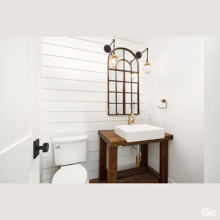 Shiplap bathroom with wood vanity with Low-Flush Toilet by Revolve Design Build
