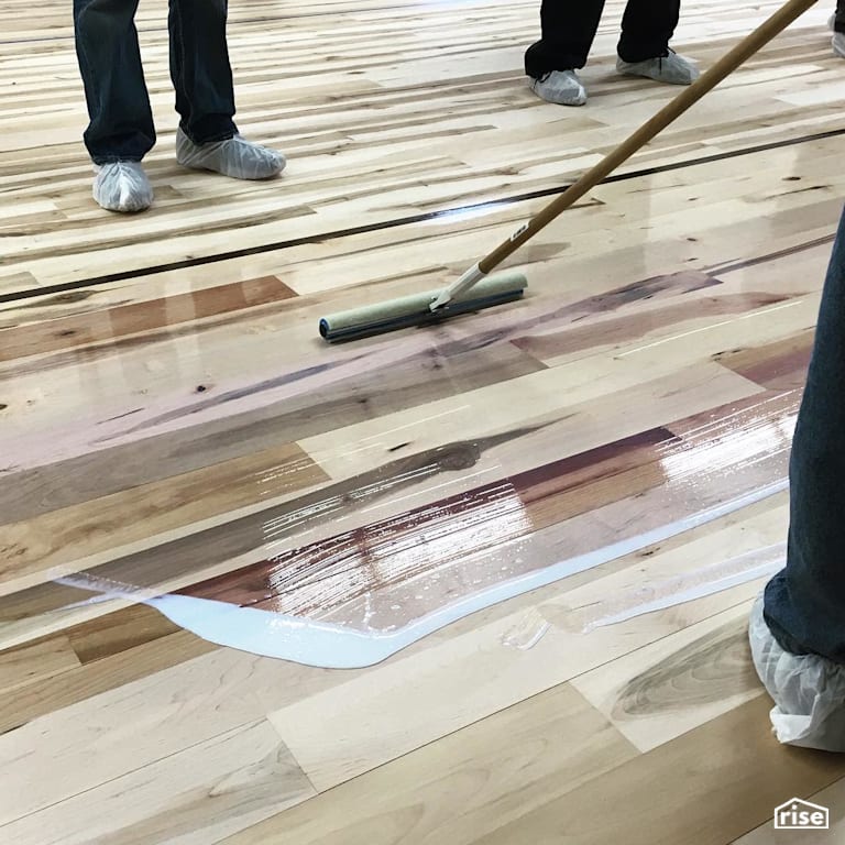 Applying wood finish to flooring with Interior Wood Finish by Vermont Natural Coatings