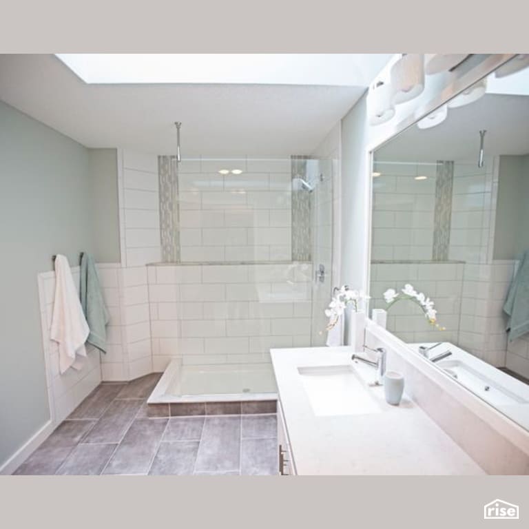 Bathroom with Low-Flow Showerhead by Constructive Builders