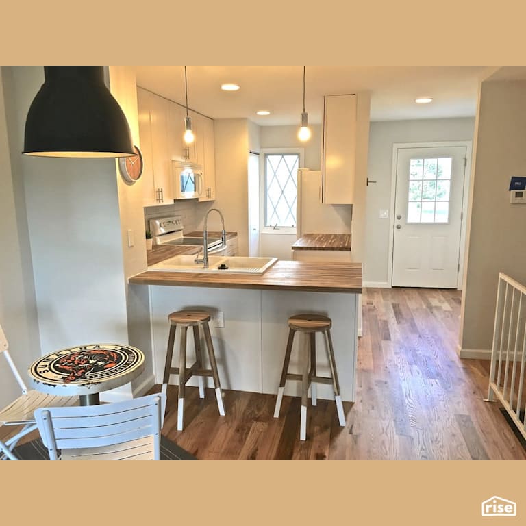 White kitchen and dining room with Energy Star Exterior Door by Revolve Design Build