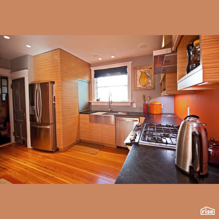 Orange Kitchen with Gas Range by RSI Projects