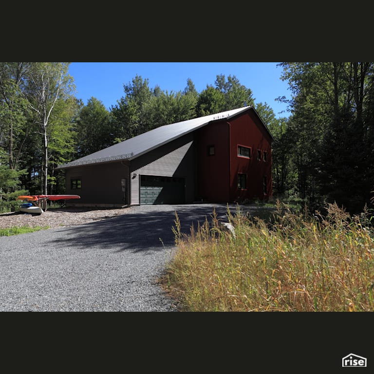 River Road Driveway with Standing Seam Metal Roof by The Conscious Builder