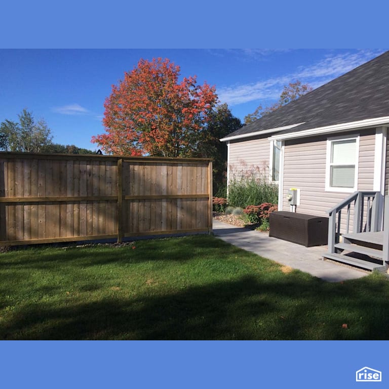 Rear Exterior with Outdoor Gardens by Earthworks Landscape & Design