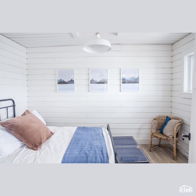 Cottage Bedroom with Laminate Flooring by Reimagine Designs