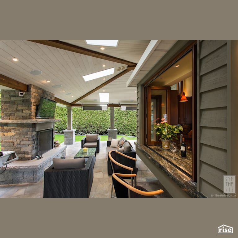 Indoor and Outdoor Bar Area with Patio Stone by Synthesis Design