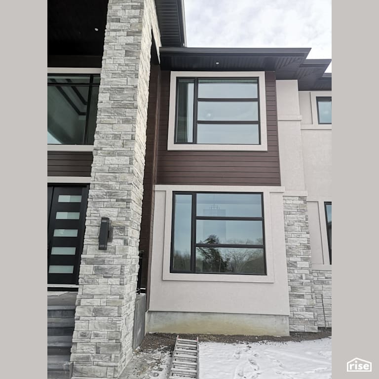 Stone veneer siding with brown composite siding with Accent Outdoor Lighting by ChamClad by Chameleon