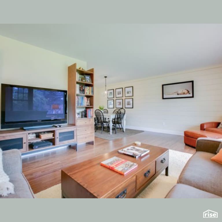 Living Room with Laminate Flooring by Constructive Builders