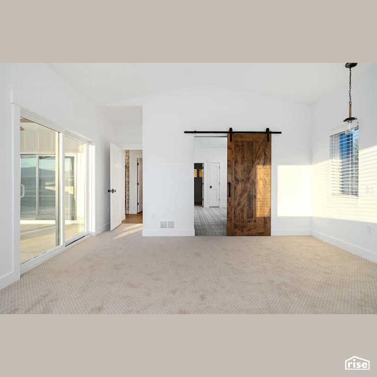 Master bedroom with sliding door to patio with Carpeting by Revolve Design Build