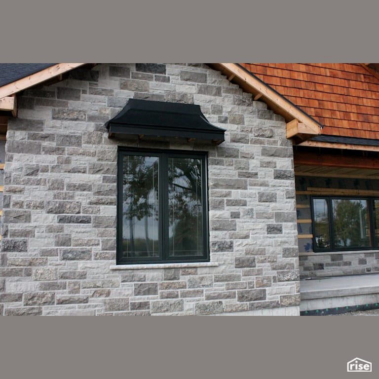 House with stone siding complimented by wood shingles with Stone Siding by Masonal Stone Inc