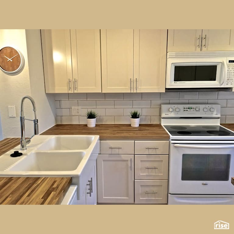Hardwood countertop with subway tile backsplash with FSC Certified Solid Wood Countertop by Revolve Design Build