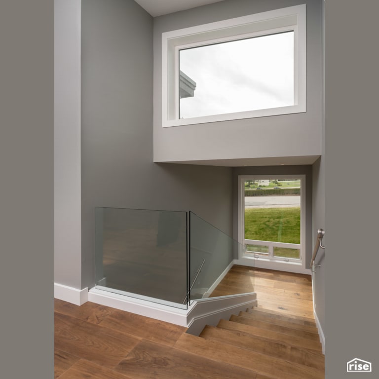 Staircase with Fixed Window by My House Design/Build Team Ltd.