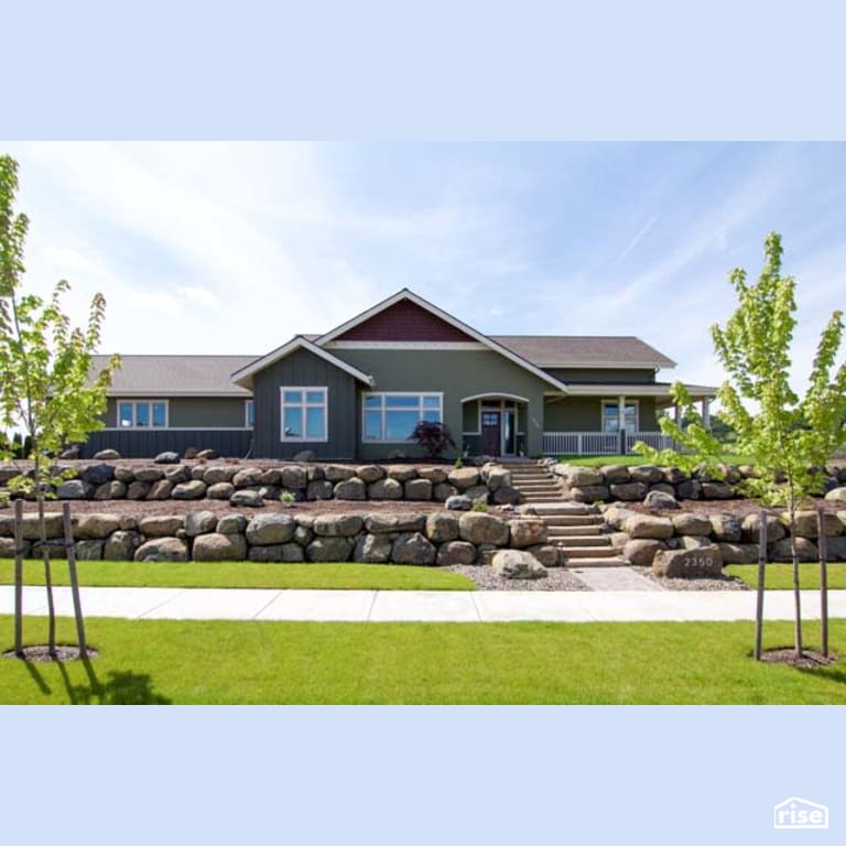 Home Exterior with Solid Wood Door by Winsome Construction