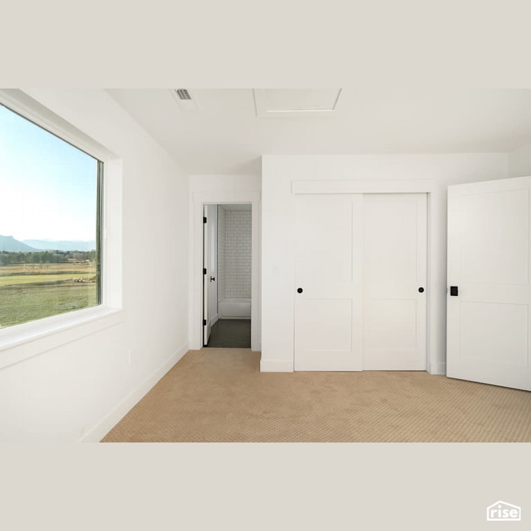 White bedroom with exterior view with Carpeting by Revolve Design Build