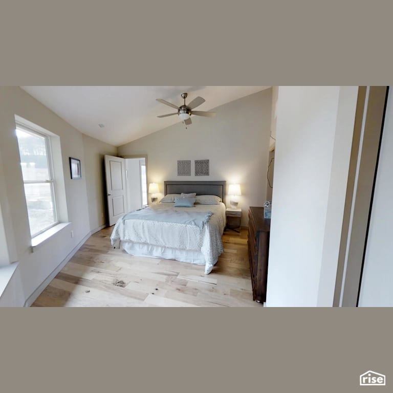 Bedroom with wide plank hardwood floors with Engineered Hardwood by Deltec Homes
