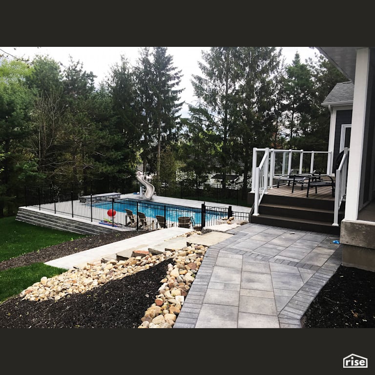 Backyard Pool with Wood Mulch by Earthworks Landscape & Design