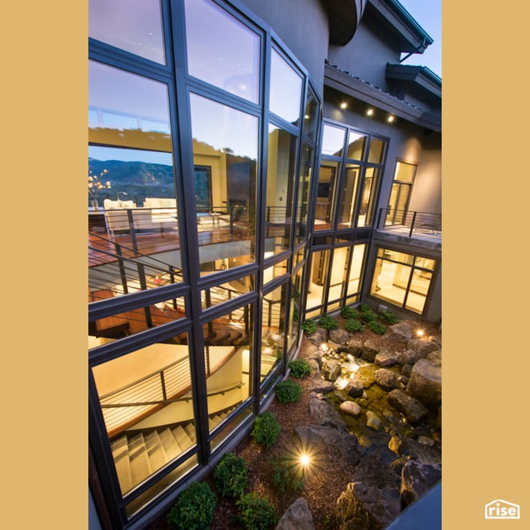 Terraced exterior landscaping with stream feature with Triple Pane Window by Alpen High Performance Products