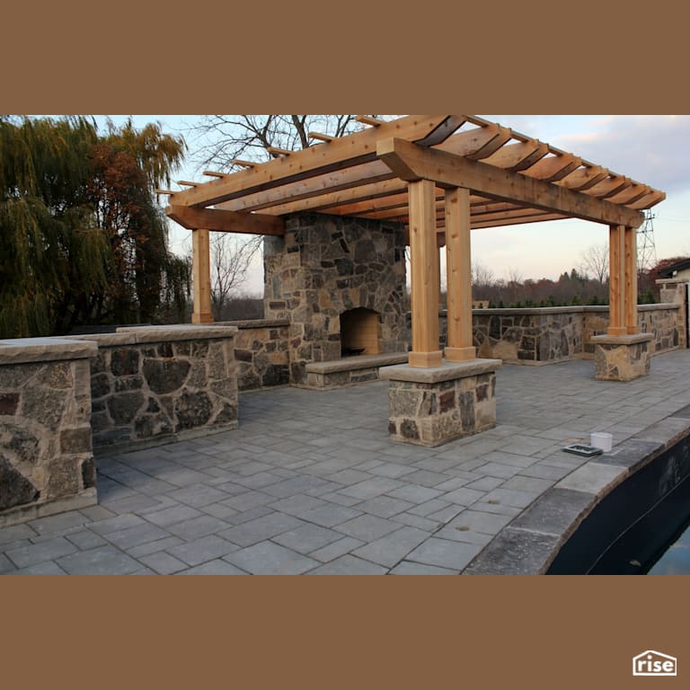 Elaborate stone fireplace next to pool with Patio Stone by Masonal Stone Inc