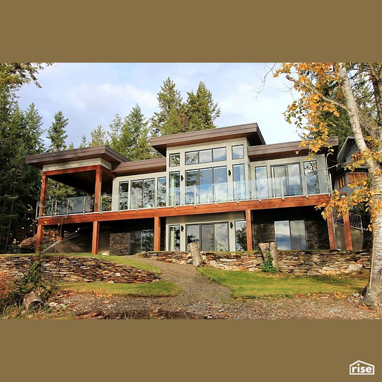 Copper Island Fine Homes - Exteriors with Stone Siding by Copper Island Fine Homes Inc.