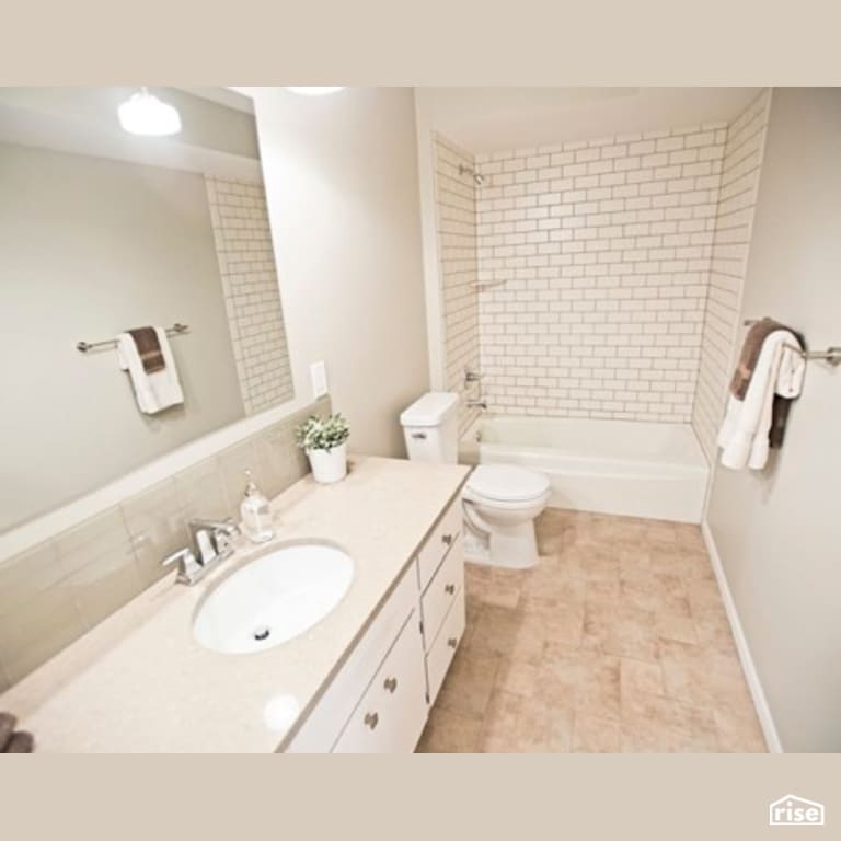 Bathroom with Low-Flow Showerhead by Constructive Builders