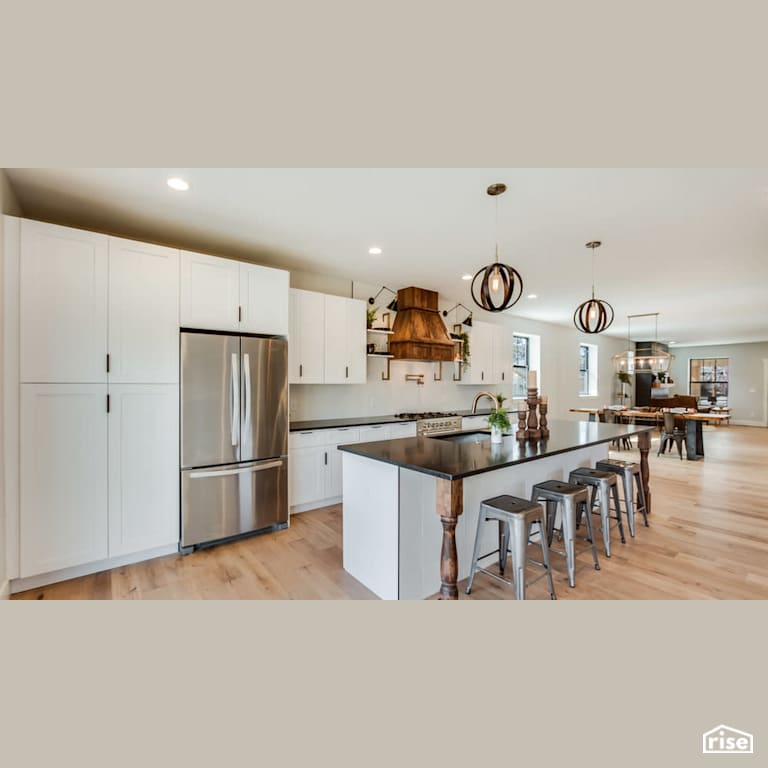 White open concept kitchen and dining room with Low-Flow Kitchen Faucet by Revolve Design Build