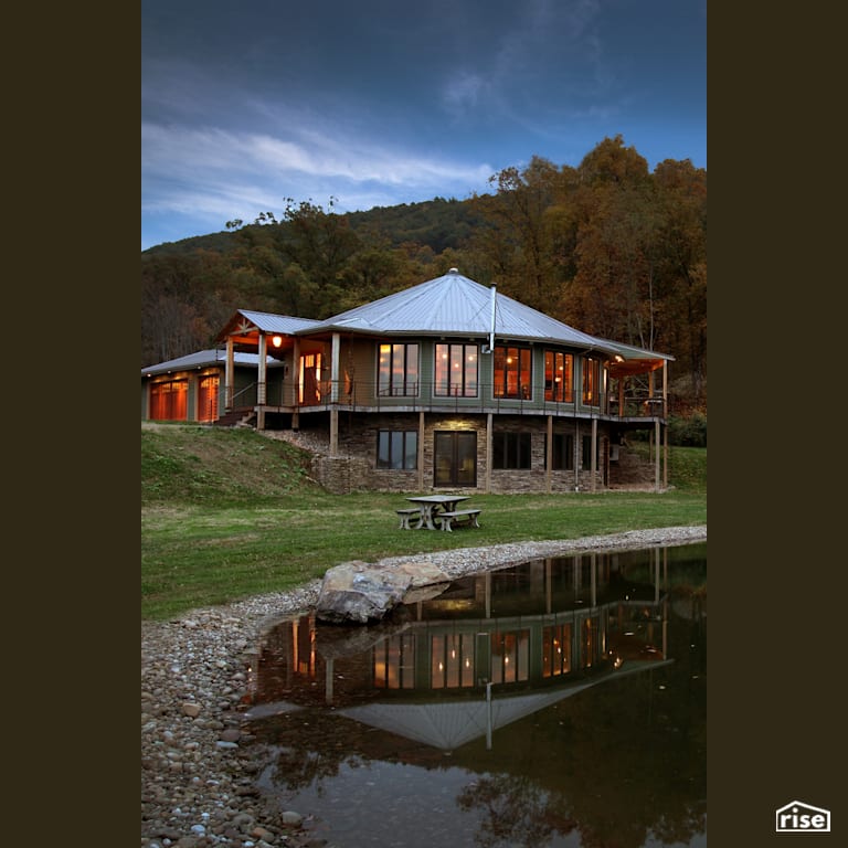 Roundhouse on the lake with Stone Siding by Deltec Homes