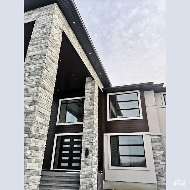 Stone veneer and brown composite siding entryway with Stone Veneer Siding by ChamClad by Chameleon