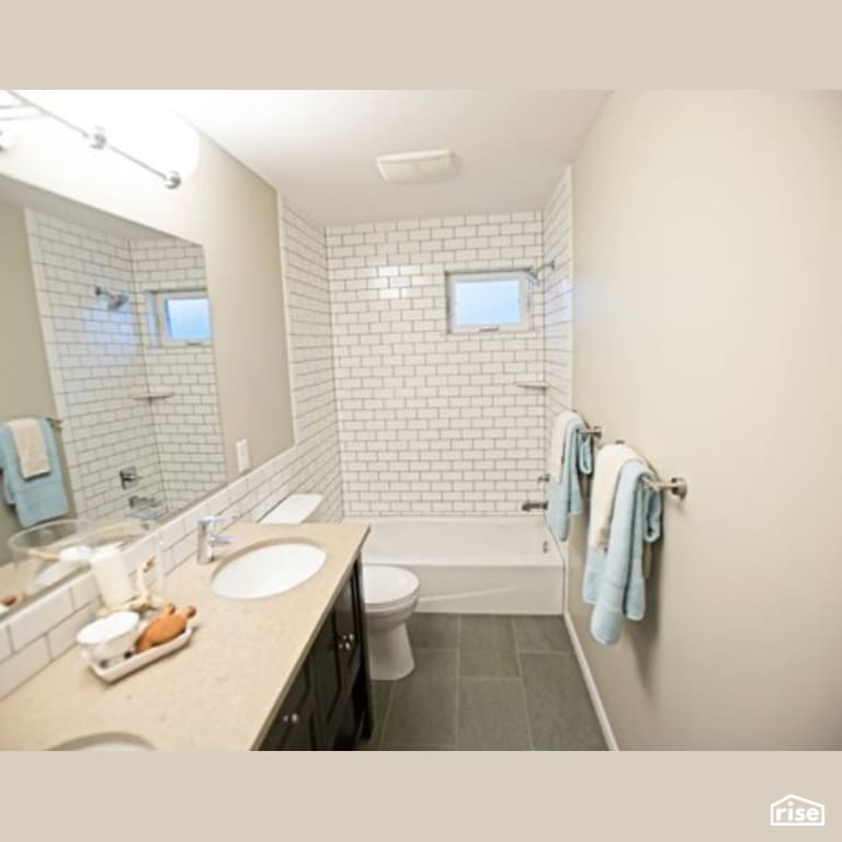 Bathroom with Low-Flow Showerhead by Constructive Builders
