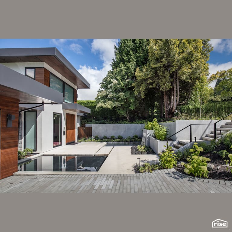 Front Yard Garden and Water Feature with Stone Veneer Siding by Synthesis Design