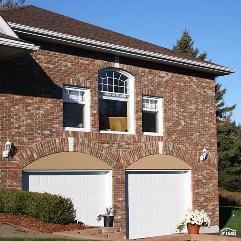 Exterior Stone Siding with Wall Mounted Outdoor Lighting by Jones Masonry